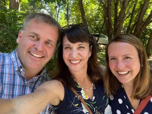 Staff members smiling outdoors.